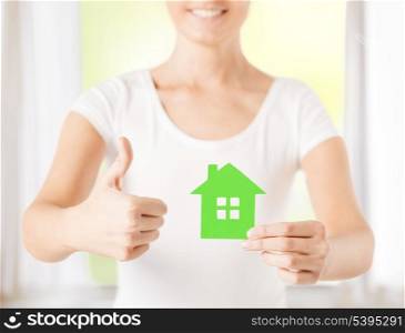 woman hands holding green house showing thumbs up