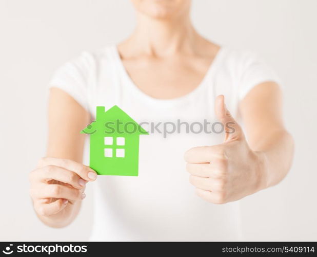 woman hands holding green house showing thumbs up