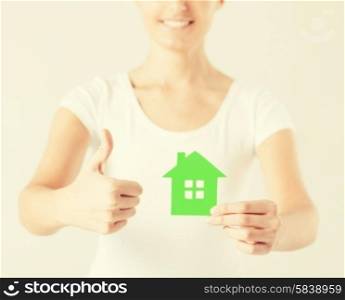 woman hands holding green house showing thumbs up