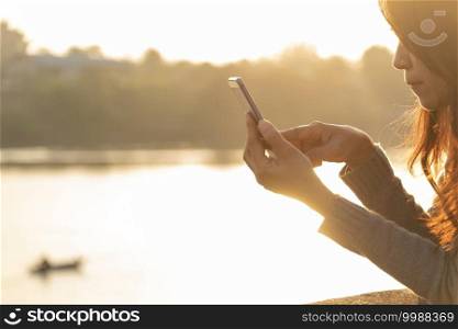 Woman hands holding mobile phone outdoor surfing internet online technology lifestyle. Close up woman hand using smartphone gadget text message focus on blank smart phone screen. Technology lifestyle