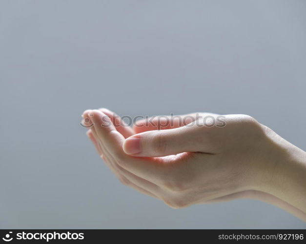 Woman hands on gray background