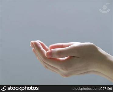 Woman hands on gray background