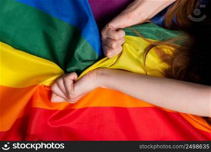 Woman hands pulling rainbow pride flag sex orgasm sign concept
