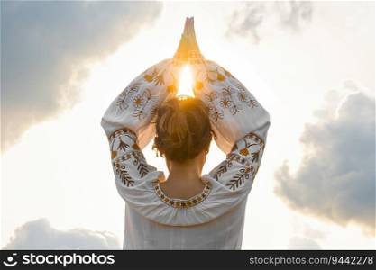 Woman, hands symbolize prayer and gratitude. Wise Yoga concept. Silhouette of female hands against background of cloudy sky and sun. Beautiful scene.. Female hands against in namaste, prayer and gratitude. Wise Yoga concept.