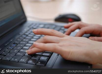 woman hands typing on laptop keyboard