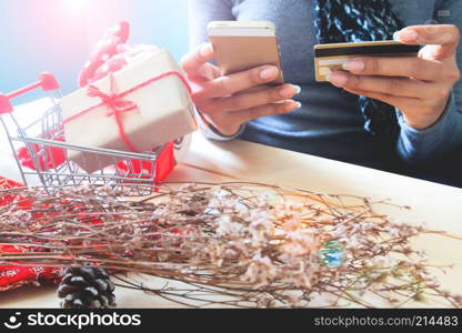 Woman hands using smartphone and credit card. Holiday online shopping