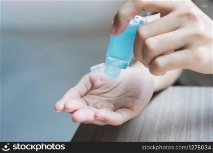 Woman hands using wash hand sanitizer gel dispenser, against Novel coronavirus or Corona Virus Disease (Covid-19) at public train station. Antiseptic, Hygiene and Healthcare concept