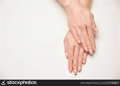 Woman hands with beautiful manicure on light background.. Woman hands with beautiful manicure on light background
