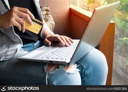 Woman hands with laptop and Credit card shopping online. Payment Transaction at Computer using Credit Card