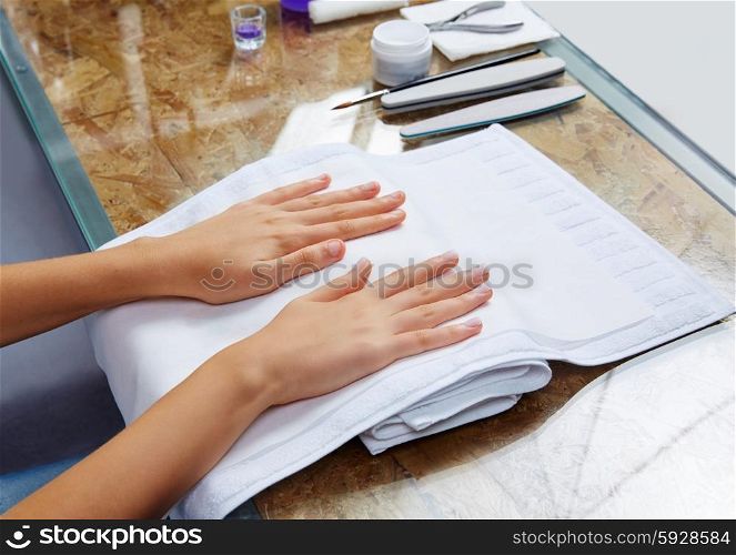 woman hands with nails before treatment on white towel in salon