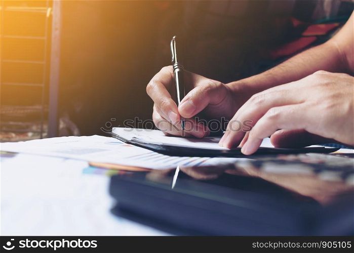 Woman hands writing note at home and calculate finance.