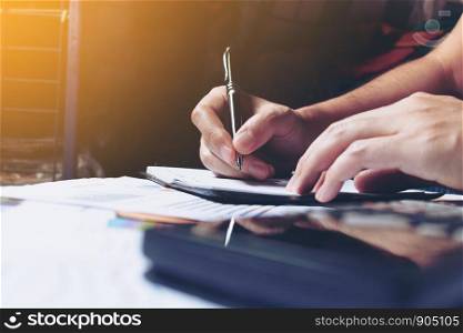 Woman hands writing note at home and calculate finance.