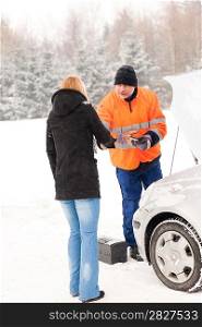 Woman handshake mechanic broken car snow help assistance winter man