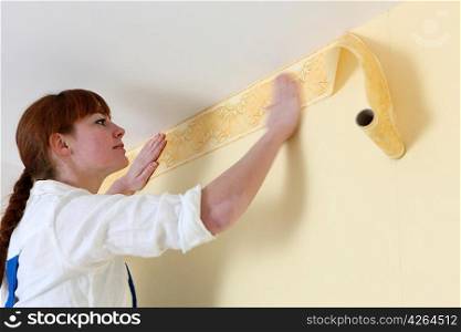 Woman hanging wallpaper motif