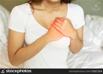 Woman have a heart attack in chest after wake up in the morning,Healthcare Concept