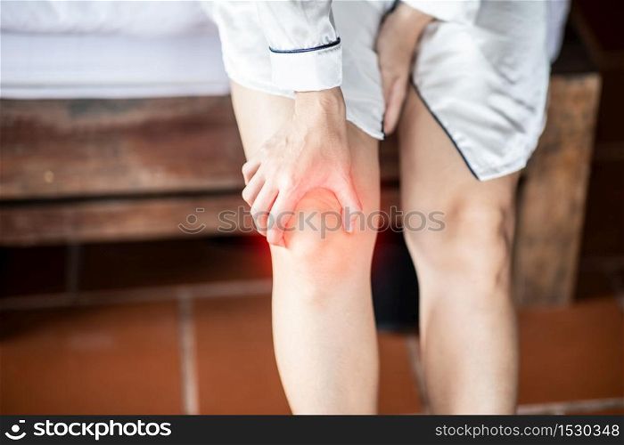 woman have a kneecap pain sitting on bed in bedroom after wake up feeling so illness,Healthcare concept