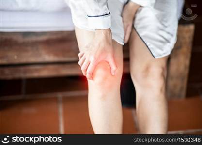 woman have a kneecap pain sitting on bed in bedroom after wake up feeling so illness,Healthcare concept