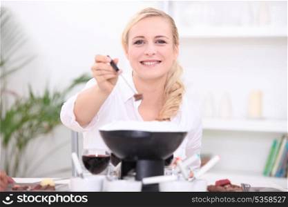 Woman having a fondue