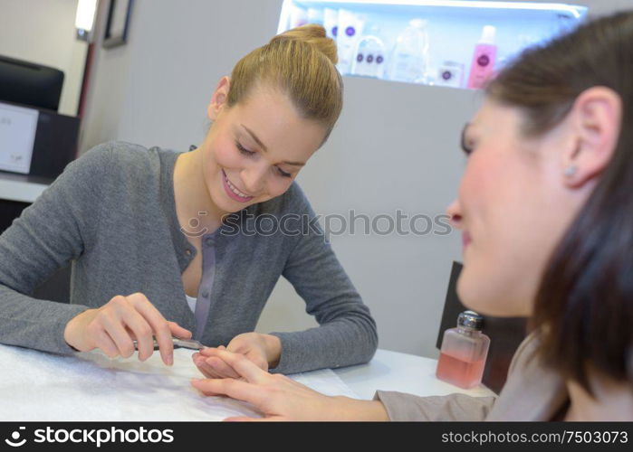 woman having a manicure done in the beauty salon