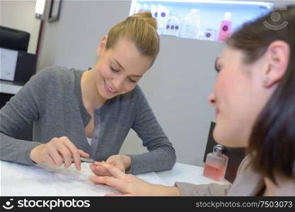 woman having a manicure done in the beauty salon