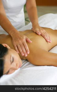 woman having a massage in a spa center