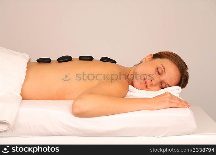 Woman having a massage with hot stones