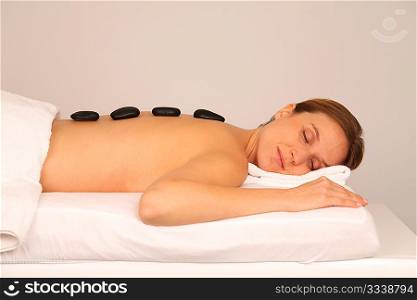 Woman having a massage with hot stones