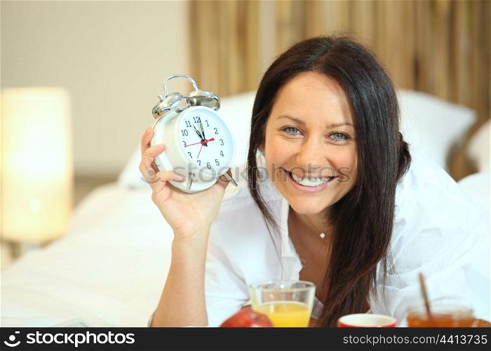 Woman having breakfast in bed at 10am