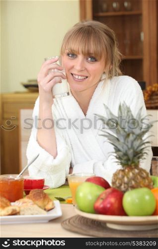 Woman having breakfast in the kitchen