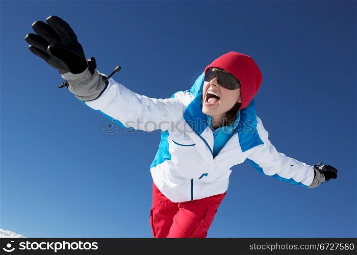 Woman Having Fun On Ski Holiday In Mountains