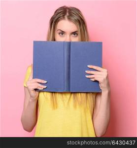 Woman having fun on study process and reading a book.