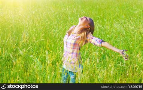 Woman having fun outdoor, enjoying fresh air and spring green grass, freedom and happiness concept