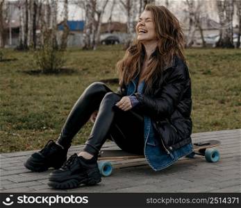 woman having fun outdoors with skateboard