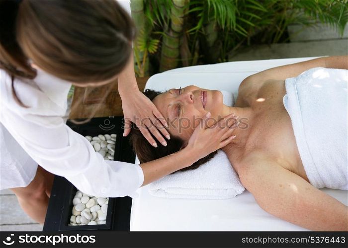 Woman having head massaged
