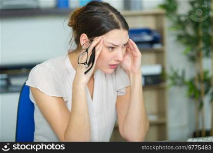 woman having headache in the office
