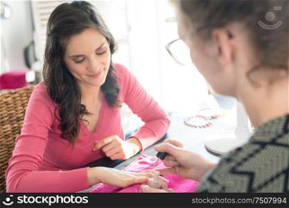 woman having her nails polished at a beauty salon