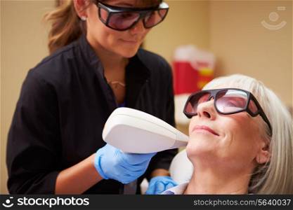 Woman Having Laser Treatment At Beauty Clinic