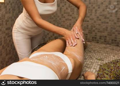 Woman having massage with cream at spa, closeup photo. Beauty, healthy lifestyle and relaxation concept.. Woman having massage with cream at spa