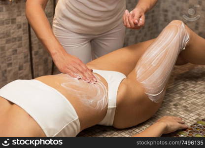 Woman having massage with cream at spa, closeup photo. Beauty, healthy lifestyle and relaxation concept.. Woman having massage with cream at spa