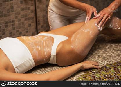 Woman having massage with cream at spa, closeup photo. Beauty, healthy lifestyle and relaxation concept.. Woman having massage with cream at spa