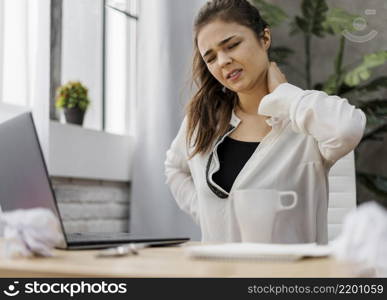 woman having neckache while working home