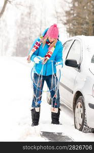 Woman having problems with car snow chains broken repair tires