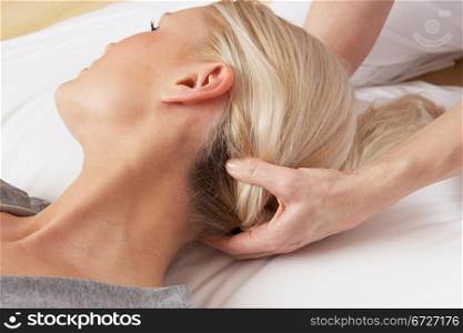 Woman having Shiatsu massage to head