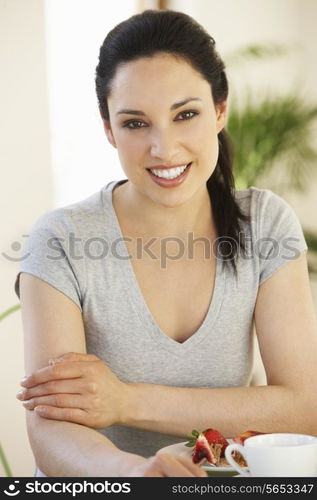 Woman Having Snack In Cafe