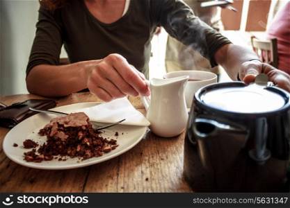 Woman having tea and cake in a cafe