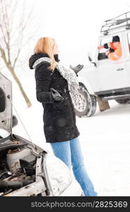 Woman having trouble with car snow assistance winter talking man