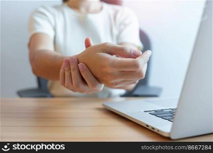 Woman having wrist pain when using laptop computer and mouse during working long time on workplace. De Quervain s tenosynovitis, rheumatism ergonomic, Carpal Tunnel Syndrome or Office syndrome concept