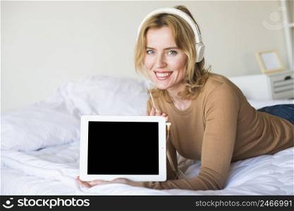 woman headphones holding tablet with blank screen