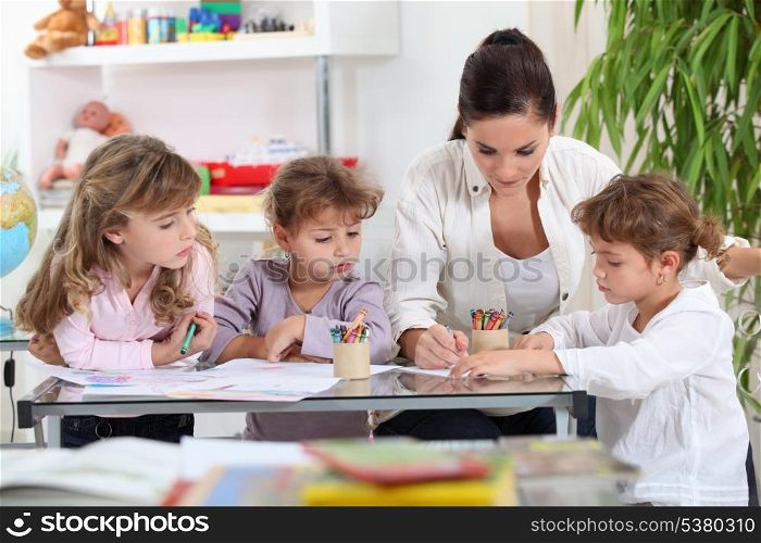 Woman helping a group of girls with their homework