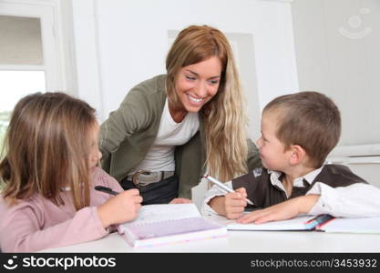 Woman helping kids with homework